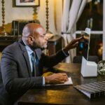 Businessman using a computer at home office during the evening.
